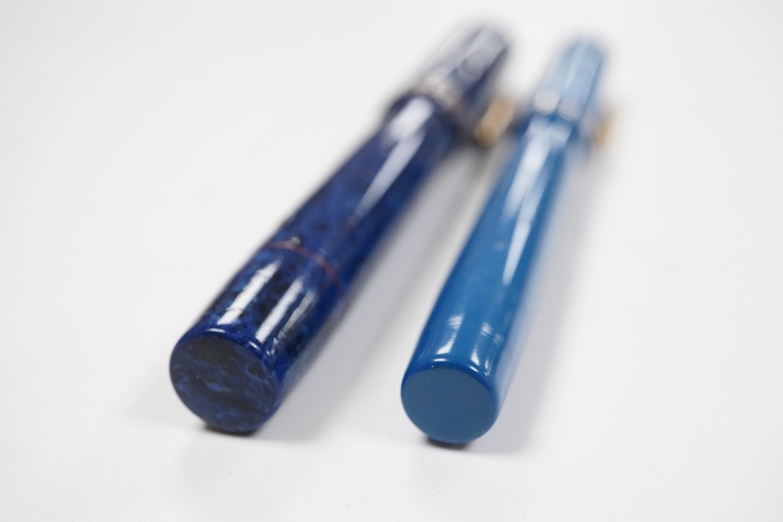 Two Conklin Enoura fountain pens in lapis blue (Senior) and a pale blue example